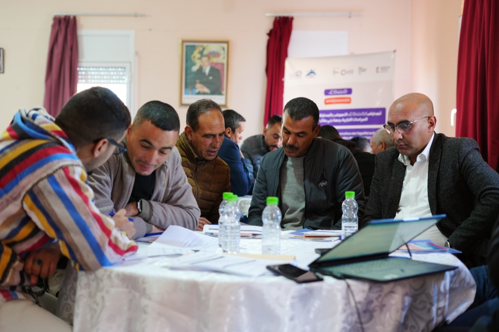 Work session — participants around documents and training materials