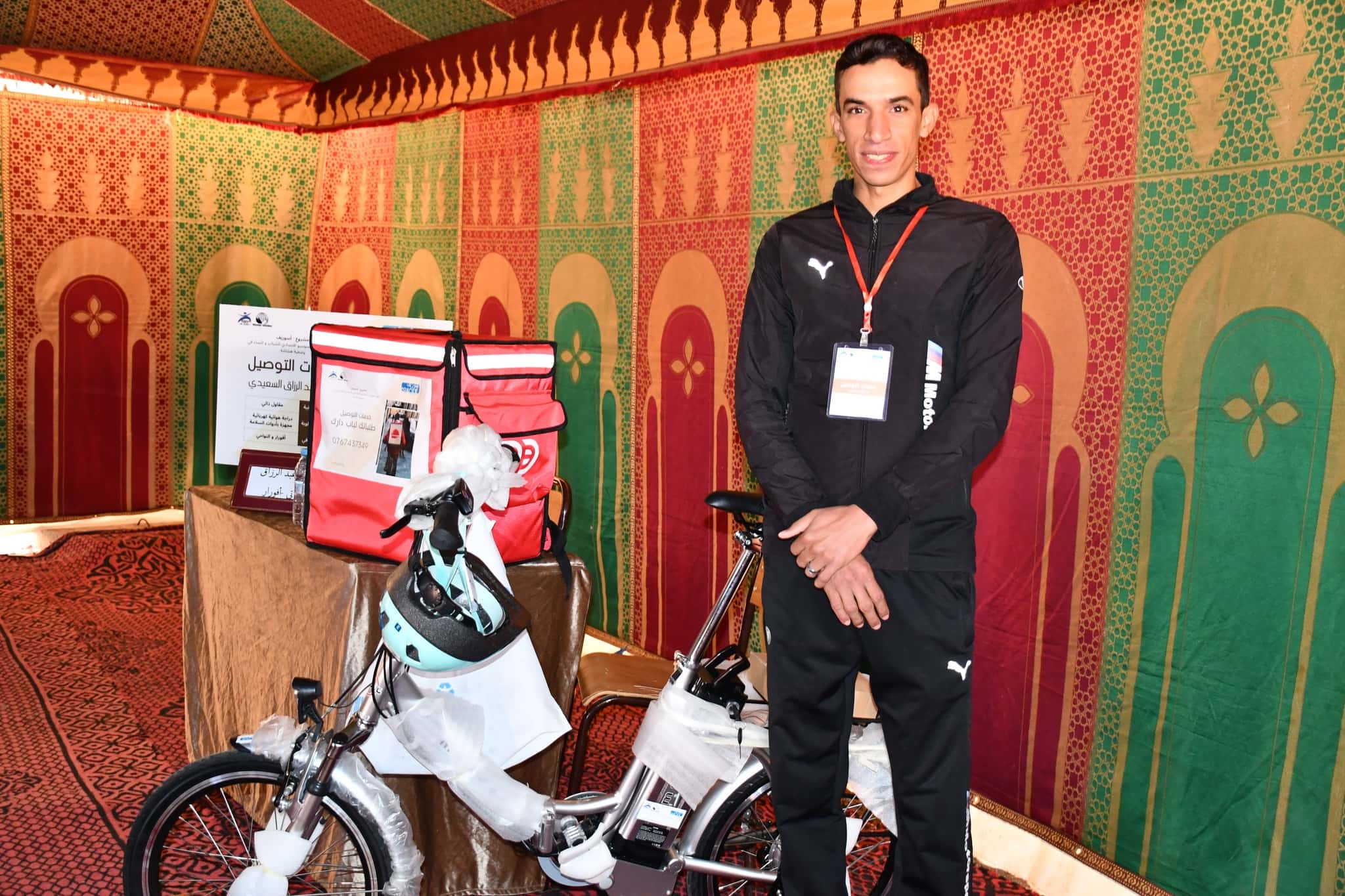 Abderzak, a beneficiary, is delighted to receive a fully equipped delivery electric bike